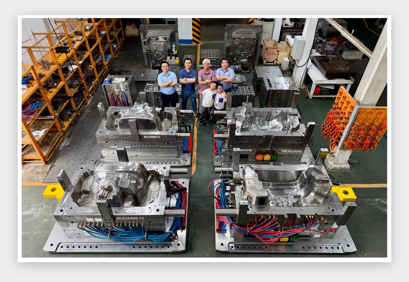 The Lap Phuc family and team with large automotive molds on the shop floor